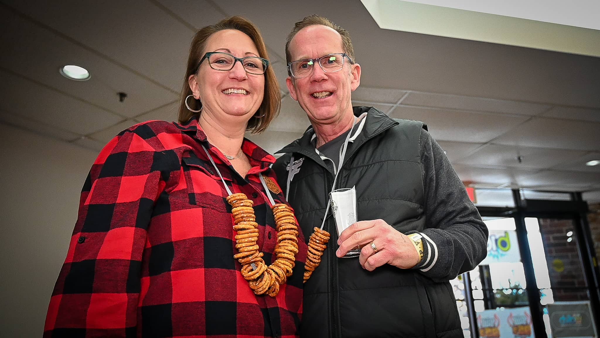 Kim and Chris White show off their pretzel necklaces on Saturday, Feb. 4, 2023, at 815 Ale Fest at the Tebala Event Center. (Photo by Kevin Haas/Rock River Current)